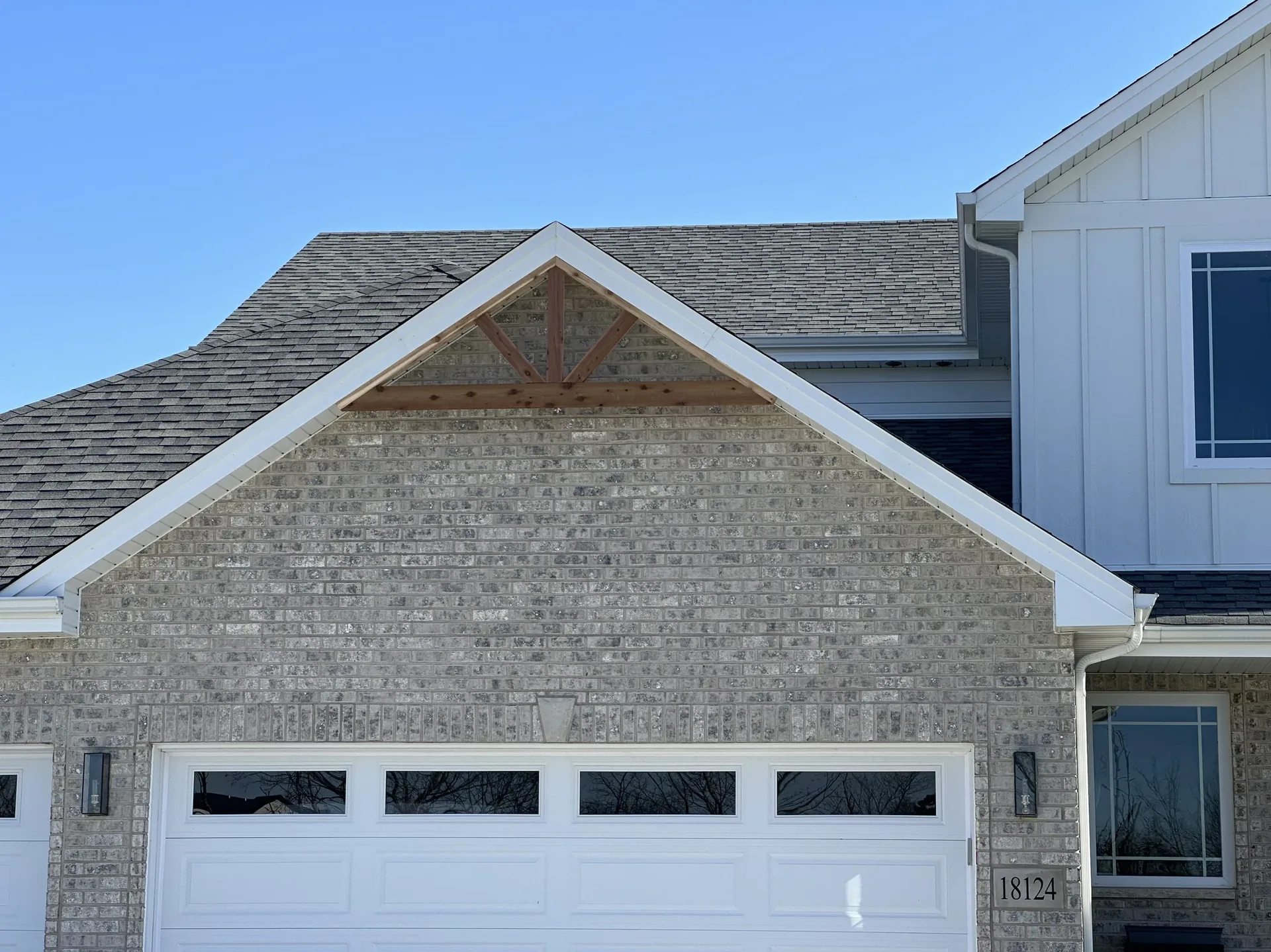 Custom brick and timber gable detail on a finished home