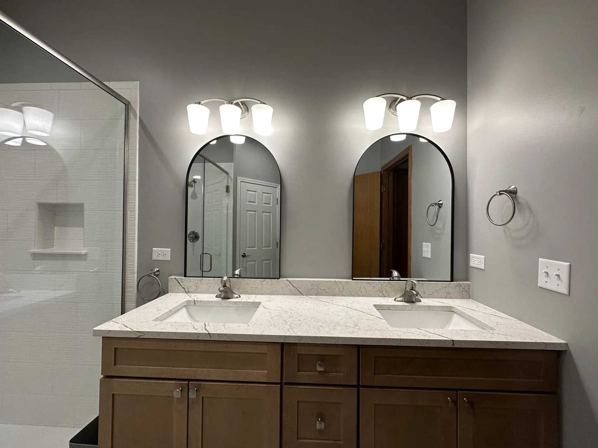 Master suite bathroom with quartz double vanity and finished tile