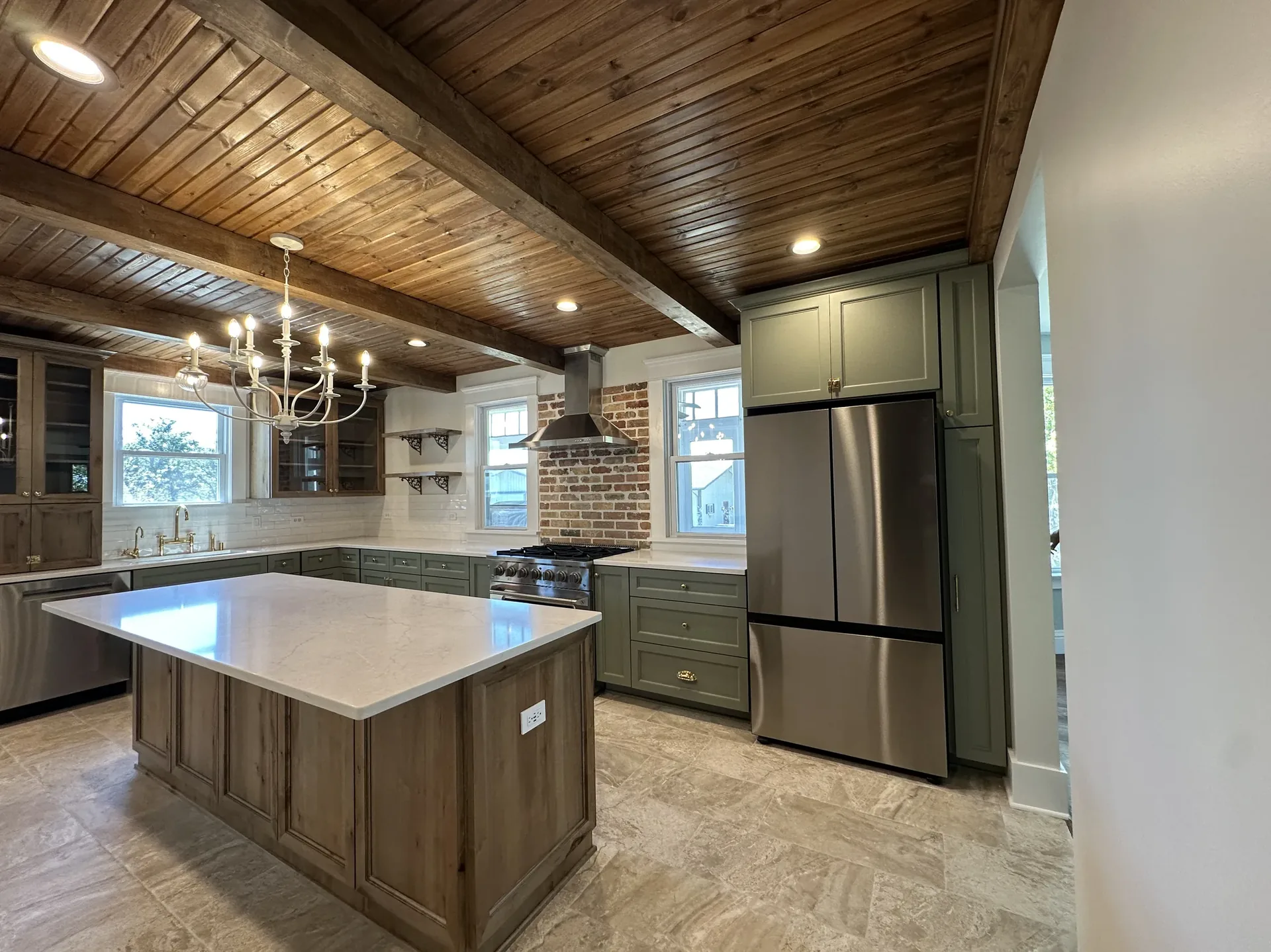 High-end kitchen remodel with custom cabinetry, beamed ceiling, and island