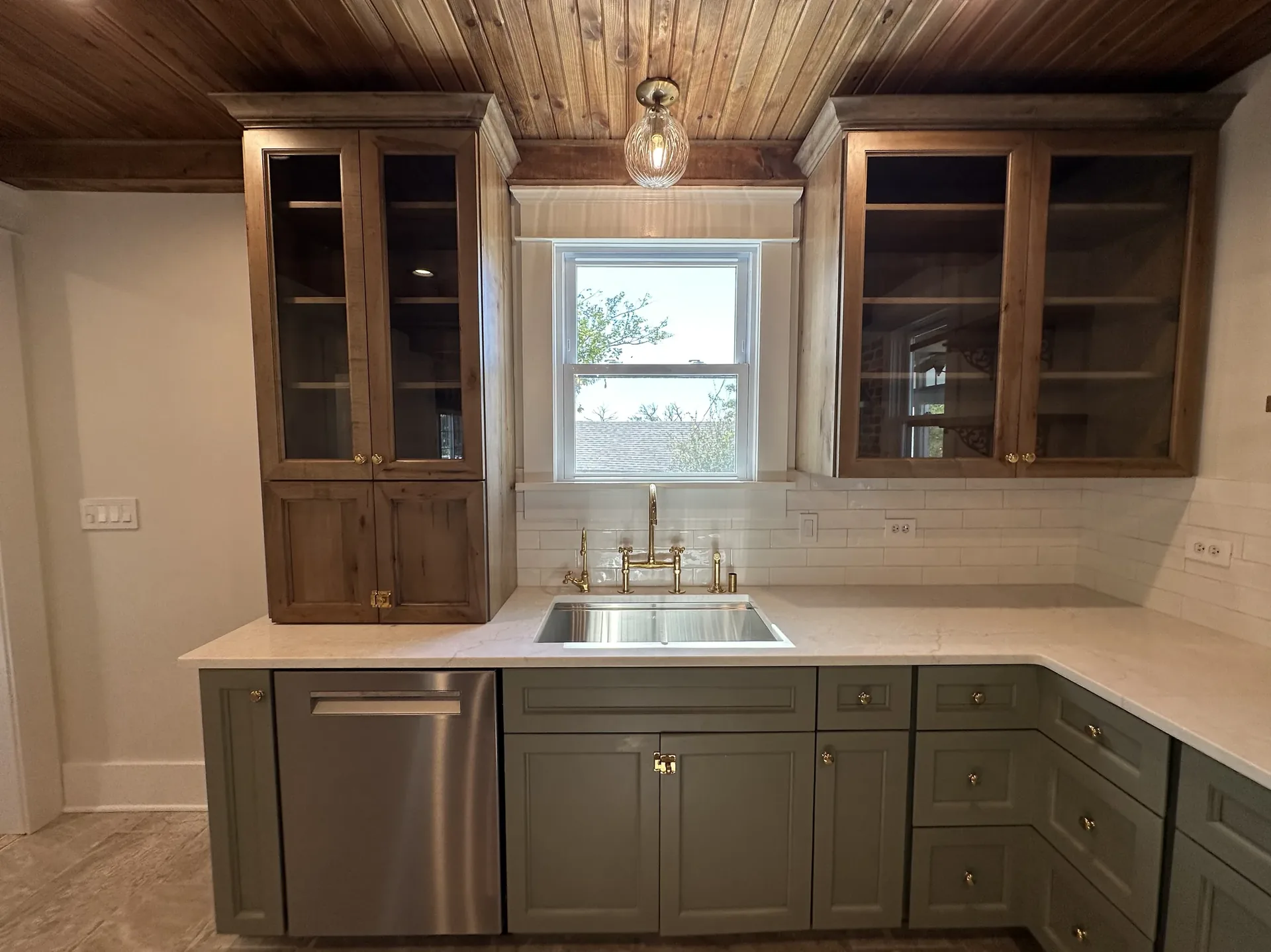 Custom cabinetry with marble counters and subway tile backsplash
