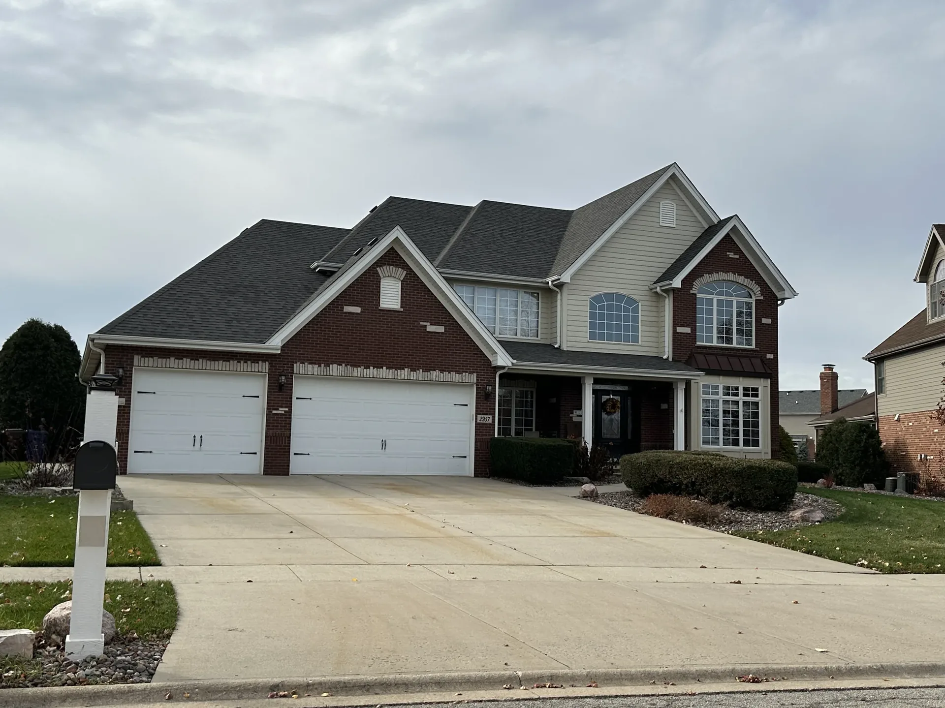 Finished brick two-story family home with three-car garage
