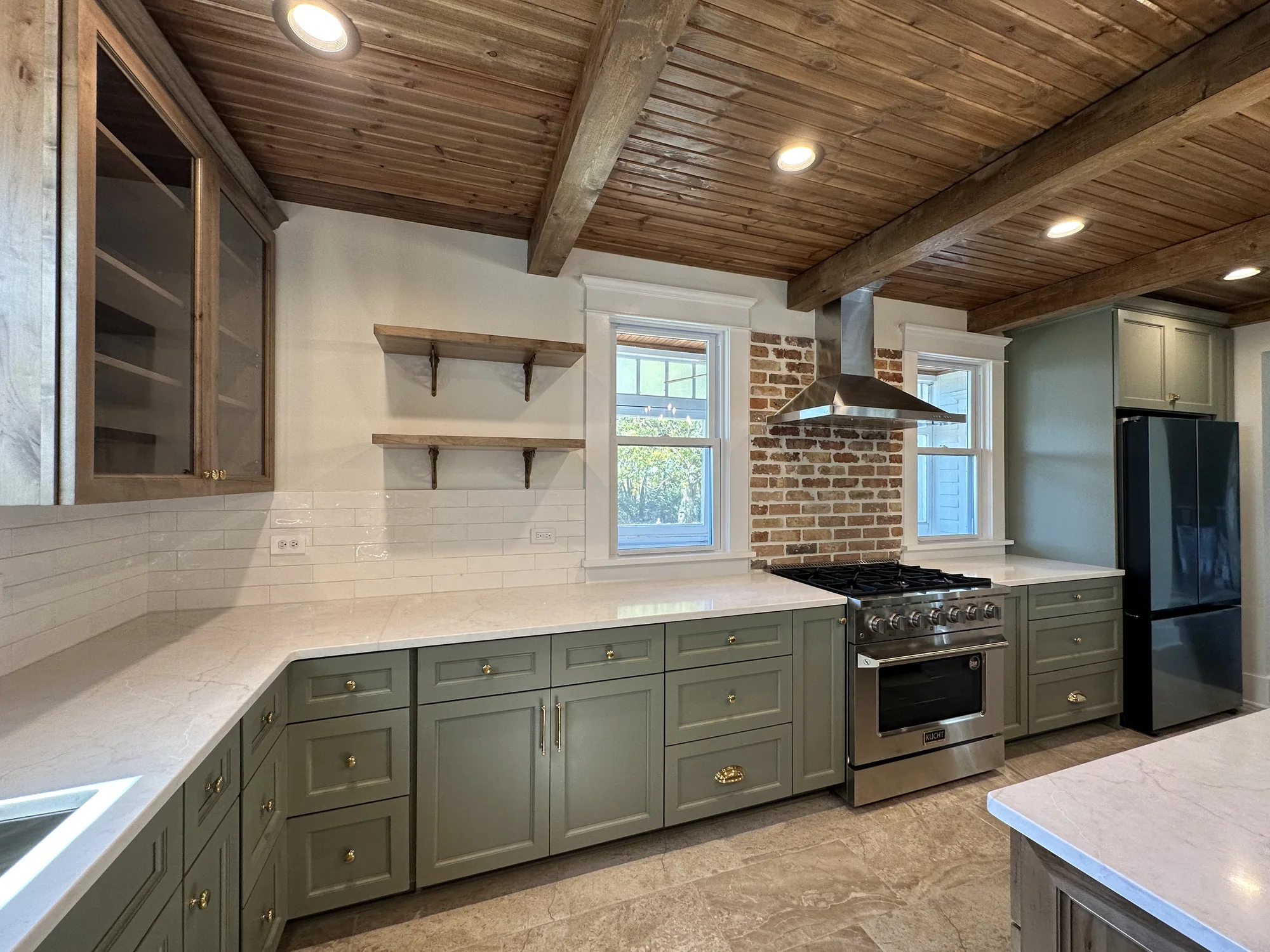 High-end kitchen remodel with custom cabinetry, beamed ceiling, and island