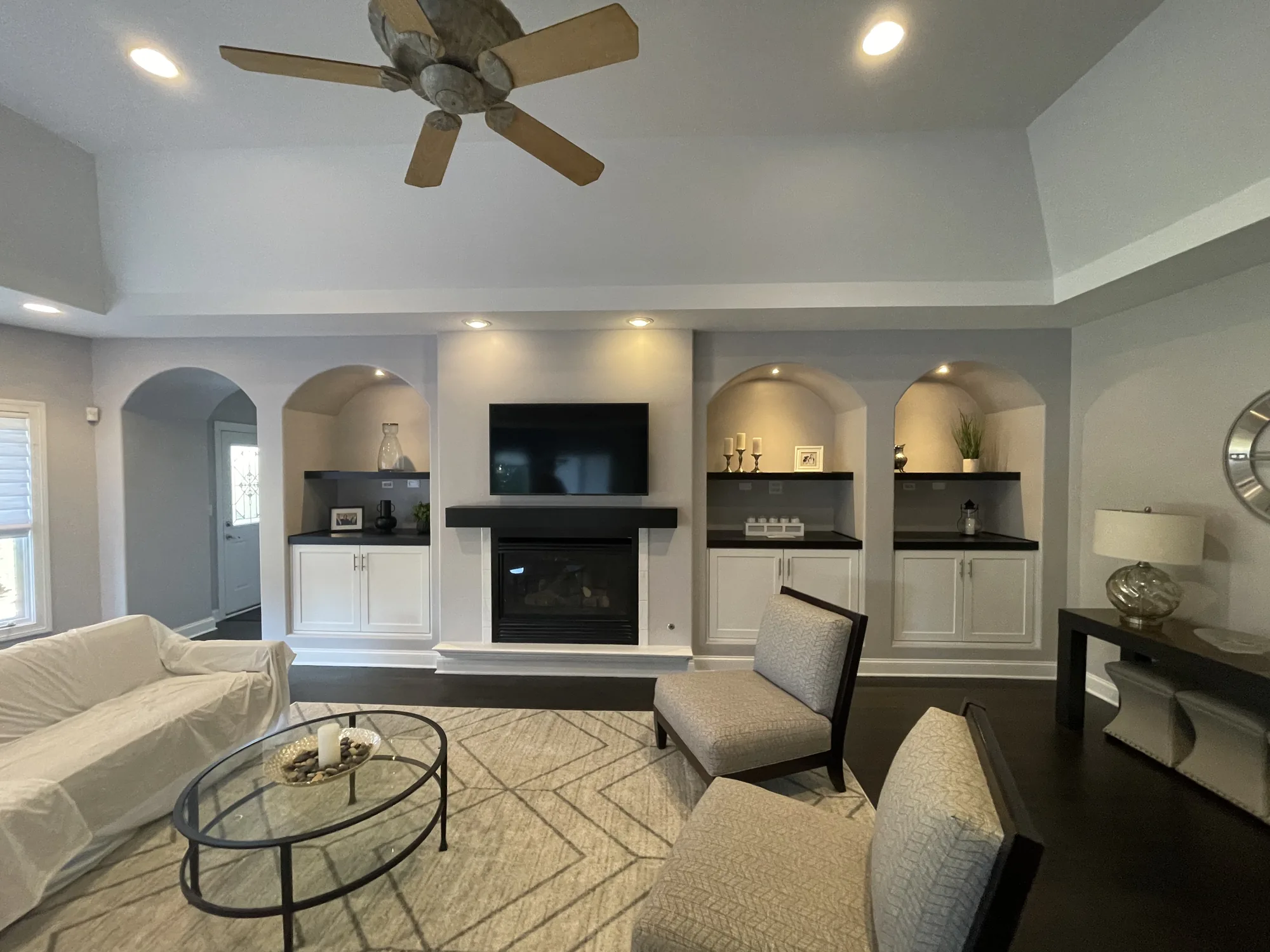 Whole-home remodel interior with stone fireplace and furnished living room